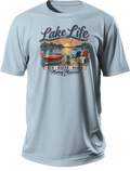 Light blue T-shirt featuring Lake Life lettering, a lakeside sunset, red boat, dockside chairs, and Sun Water Boats Making Memories text.